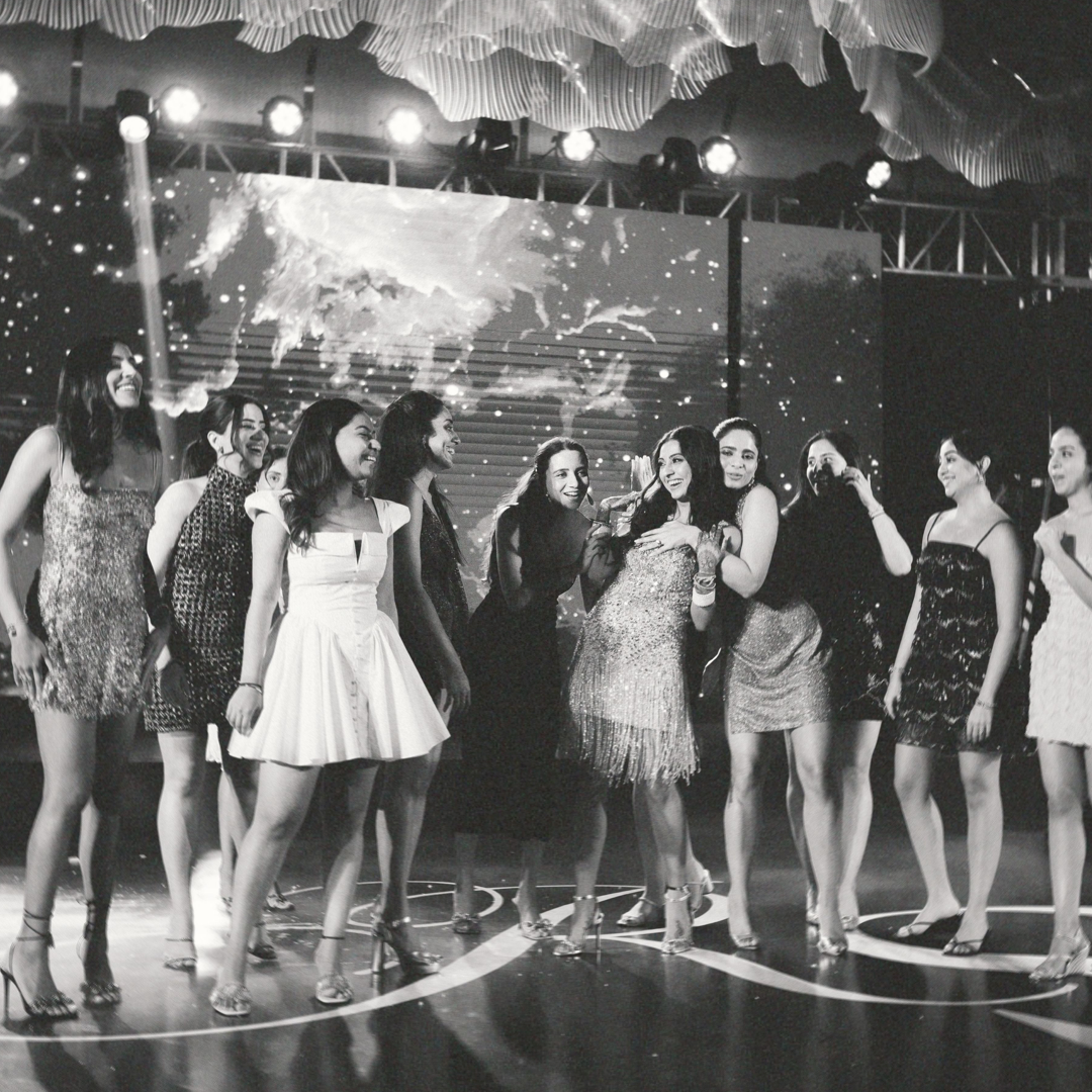 Friends dancing together on stage at a Sangeet